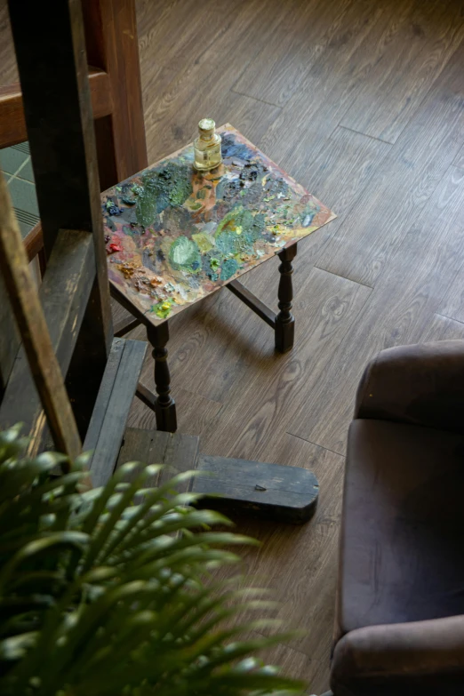 a small table sits on the floor with bottles on it