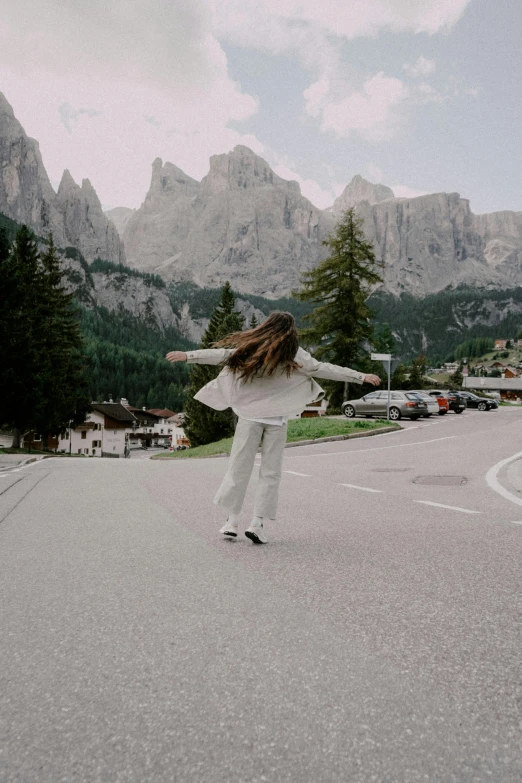 the girl in the street is skating her skateboard