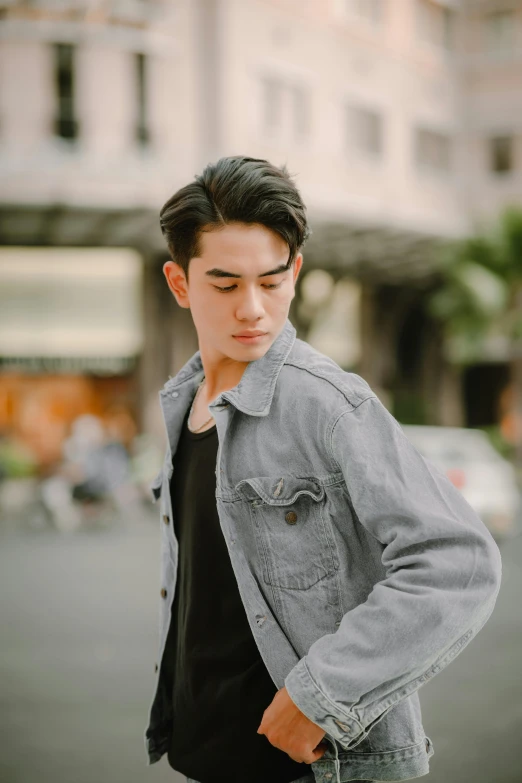 a man posing on the street in front of a building