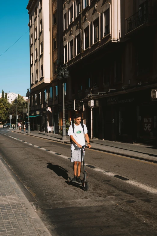 a person that is riding a scooter in the street