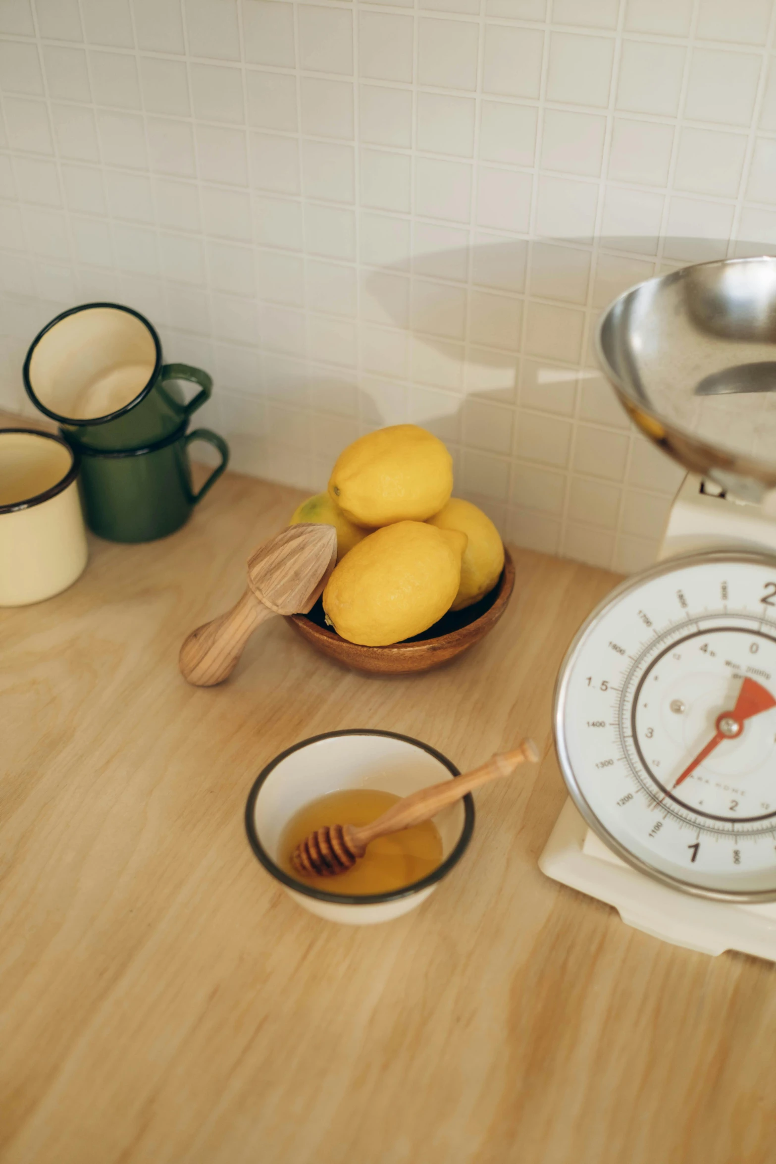 there is a bowl and bowl with lemons on a table