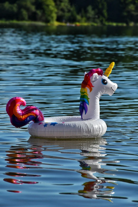 a paper mache unicorn floating in a lake