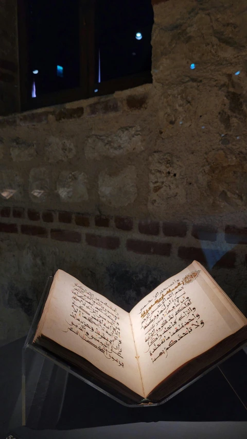 a book on top of a table lit up by lights