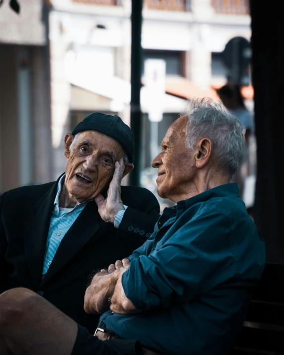 a close up of two people sitting on a bench