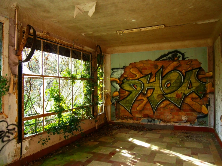 a room with graffiti on the wall and a big window