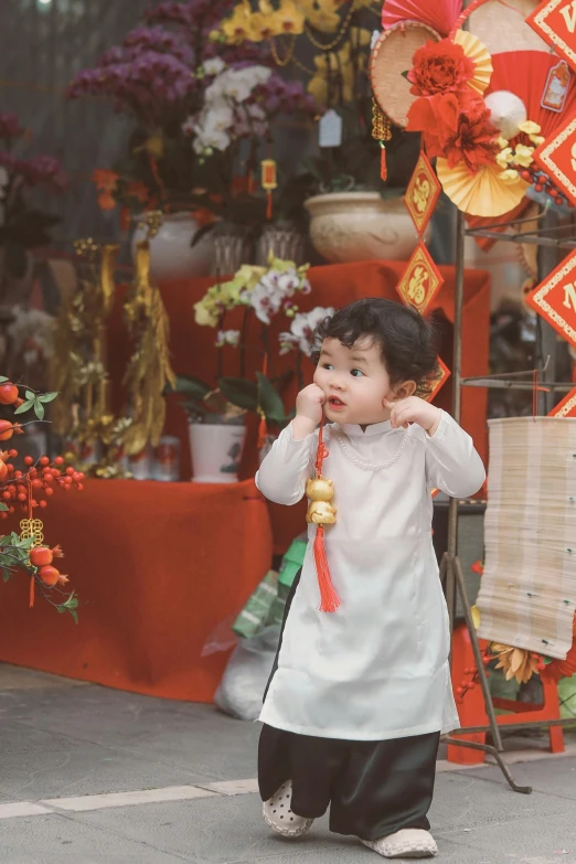 the little girl is dressed up in traditional clothes