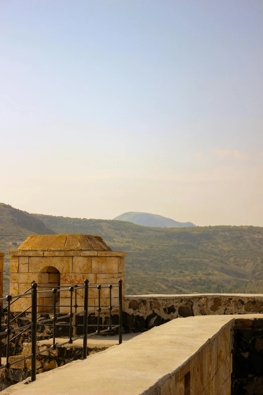 a bench near a building sitting in front of a mountain