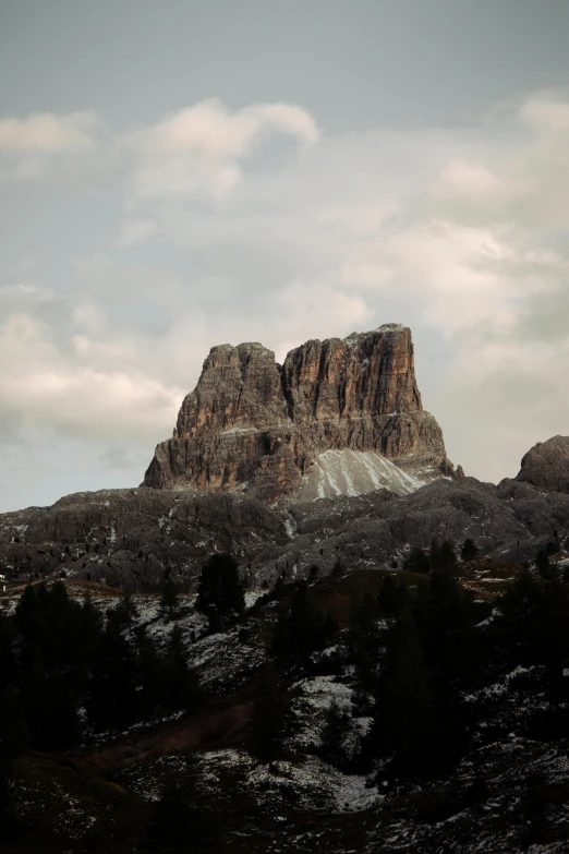 some large rocks with a snowy slope in the foreground