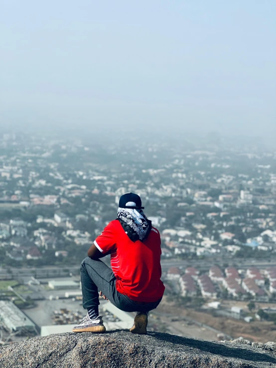 a person sitting on top of a rock