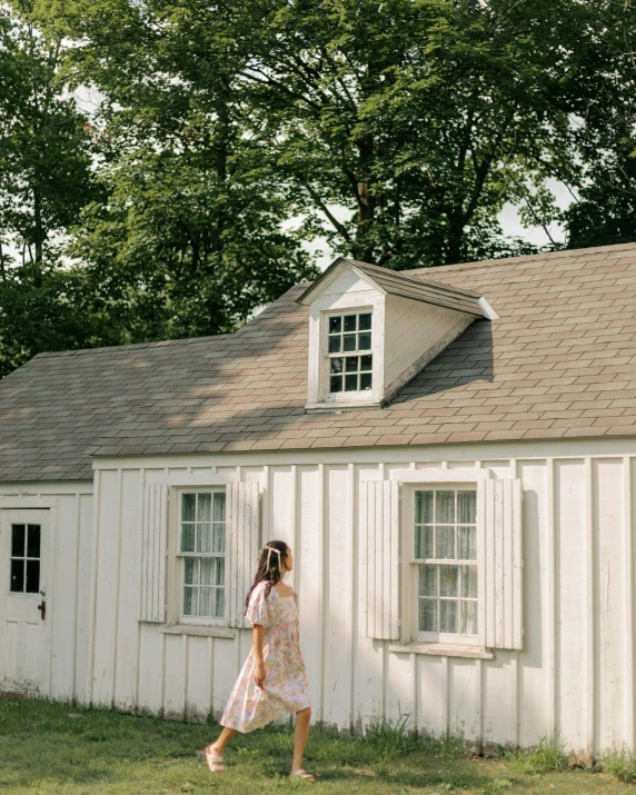 woman walking in front of an old run down building