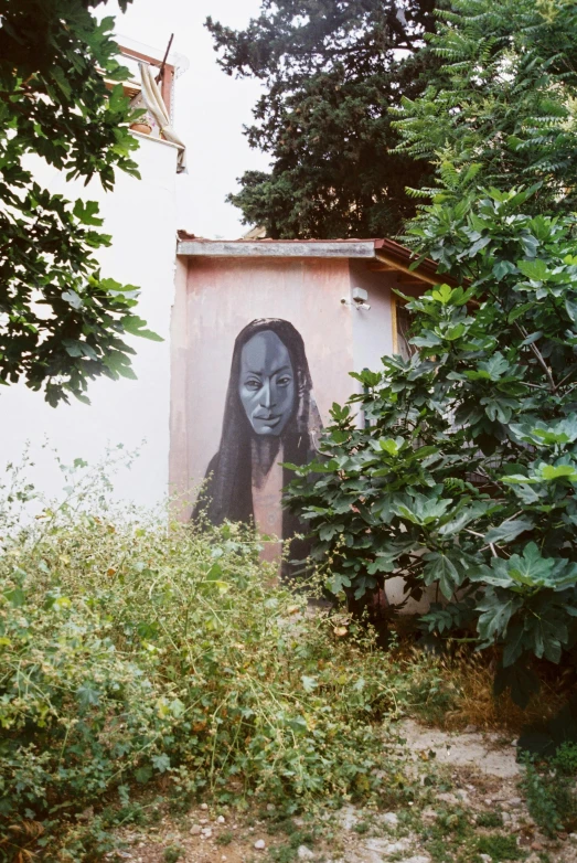 a face is shown on the wall of this house