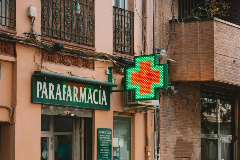 a green sign above a store in a city
