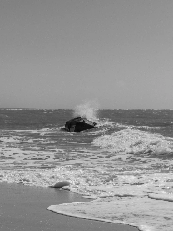 the ocean has white foamy waves and large rocks