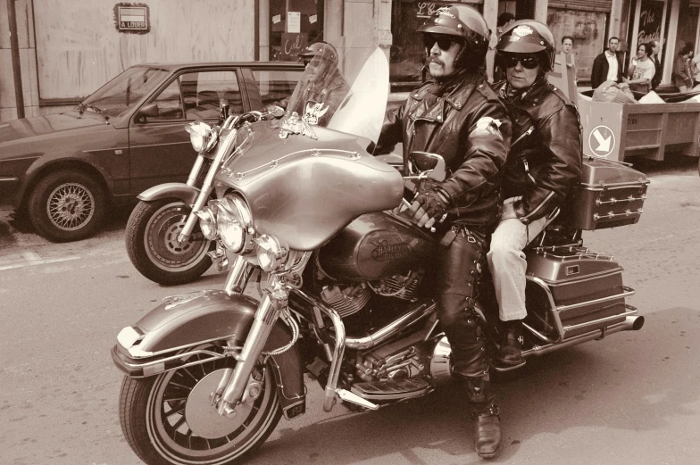 two people riding on a motorcycle in the street