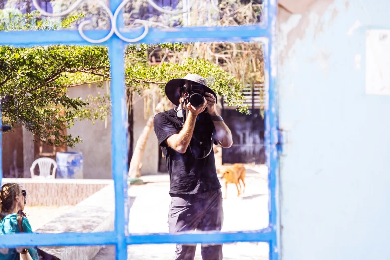 a man standing in front of a mirror holding a camera