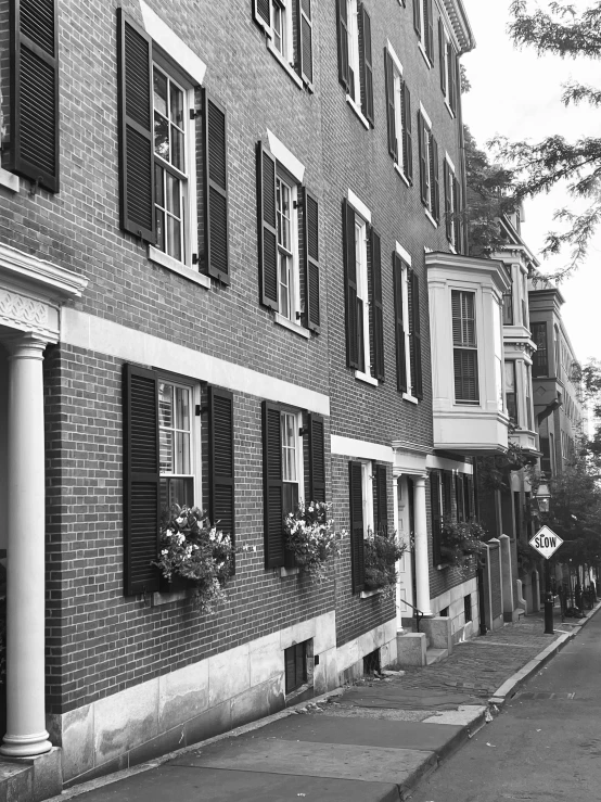 a brick building with black windows and white trim on the side of the building