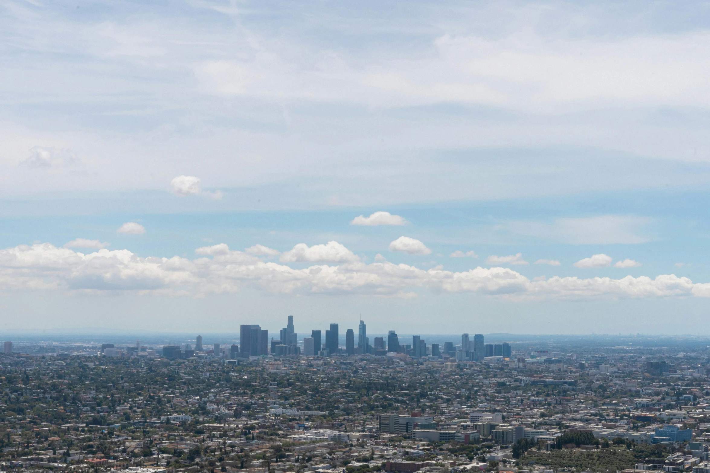 a cityscape with buildings on a partly cloudy day