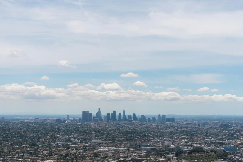 a cityscape with buildings on a partly cloudy day