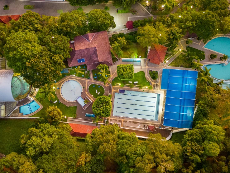 a aerial view of a large complex and a pool