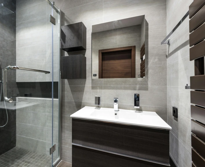 there is a modern bathroom that features grey tiles
