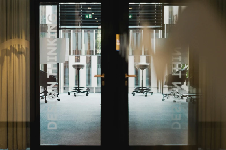 an open glass office door with a view outside