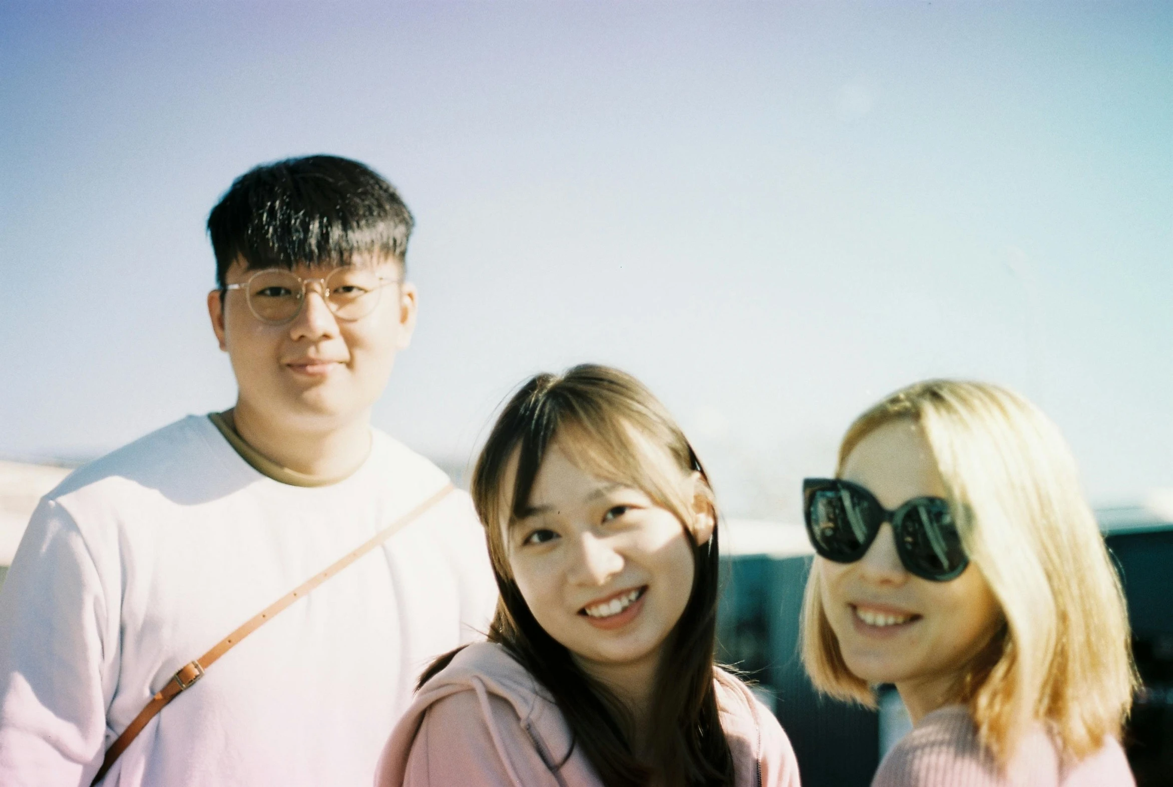 three people, all smiling for the camera