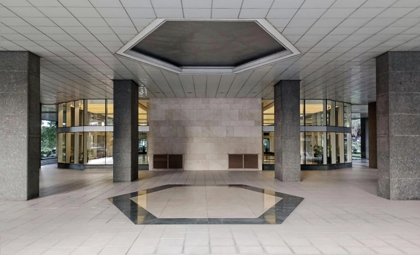 a empty floor with pillars and windows in a large building