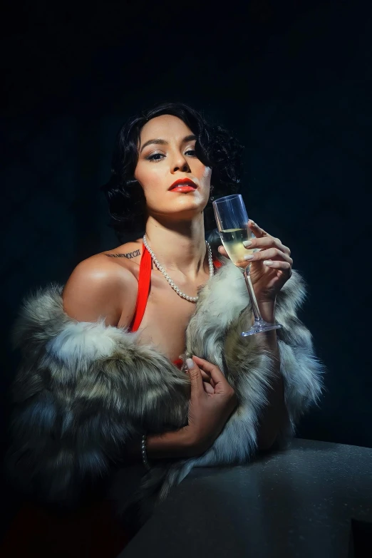 a woman in red posing for the camera with a glass of champagne