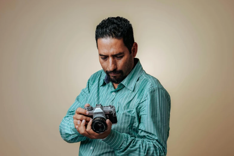 a man in blue shirt looking at a camera