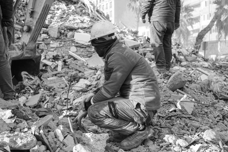 men stand near rubble in an old city