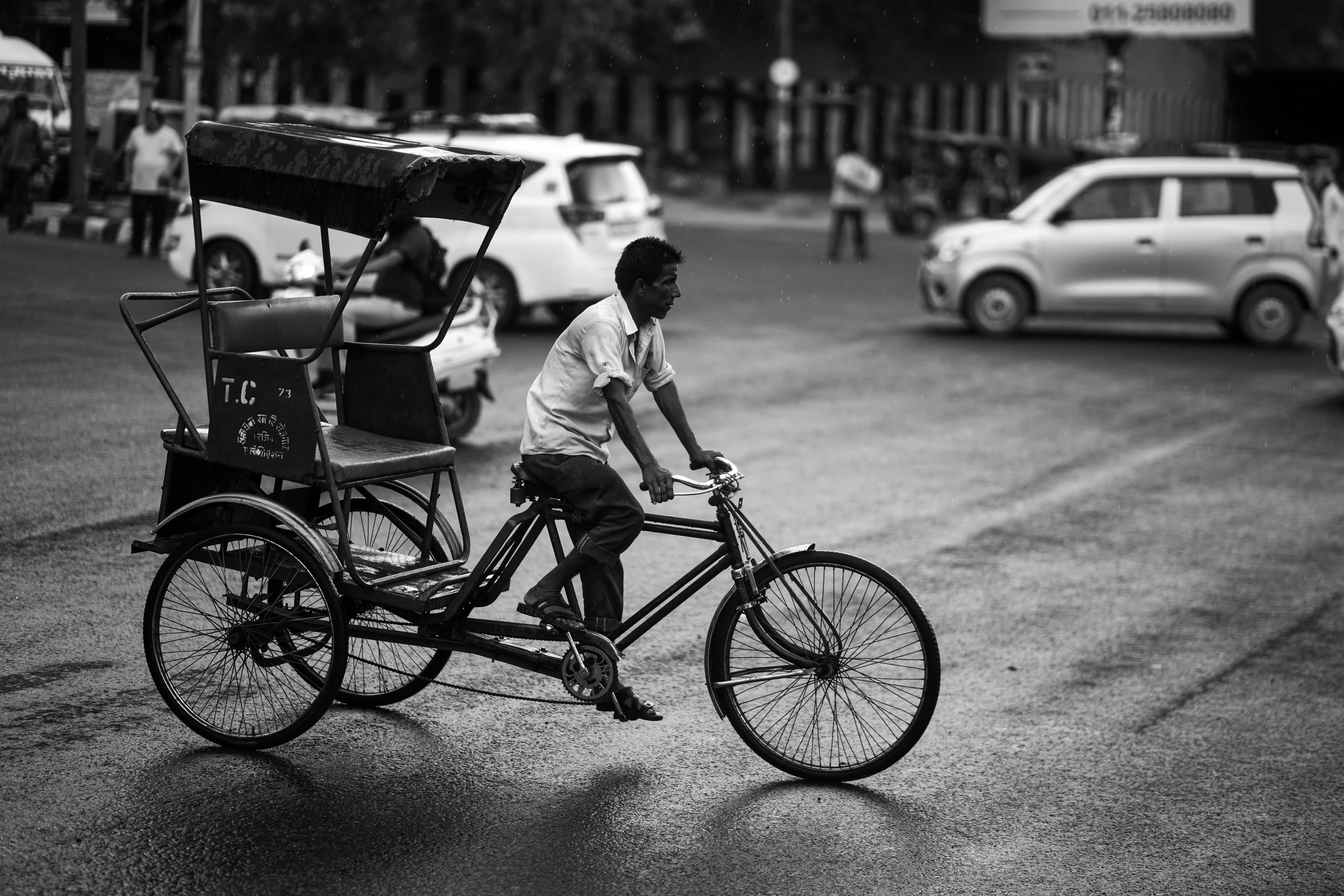 a man rides a rickshaw that has an attached cart