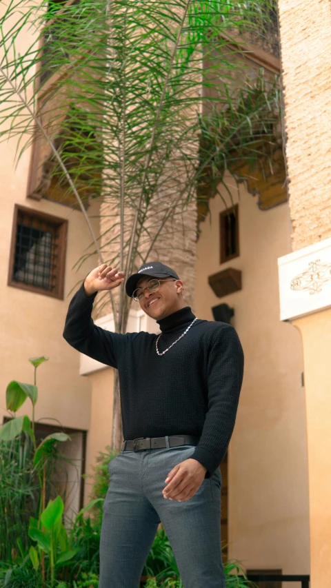 a man standing outside in front of a tall building