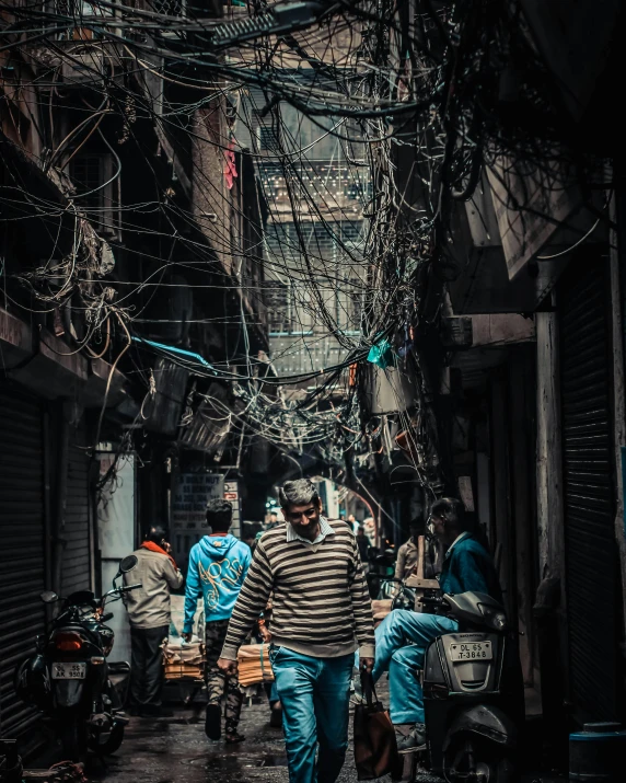 an alley with a group of people walking down it