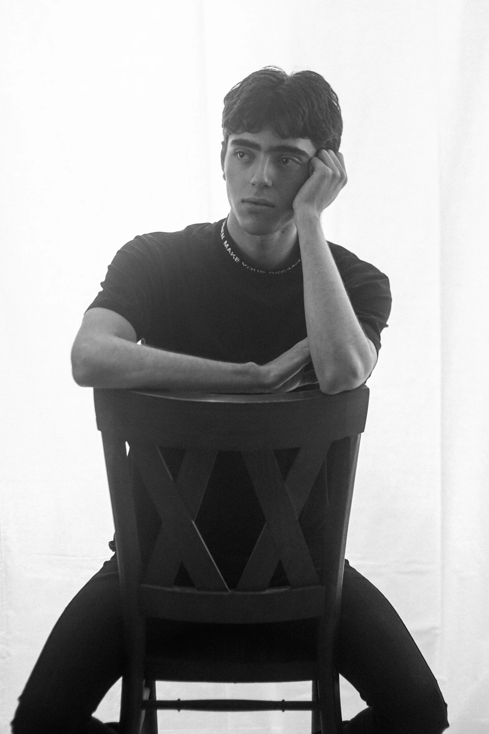 a person sitting on a chair looking pensive