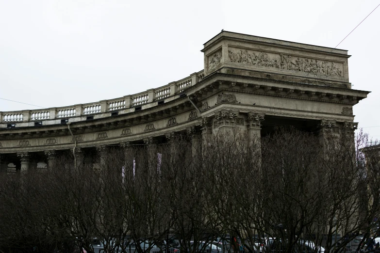 an old stone building with some ornate design and nches in the foreground