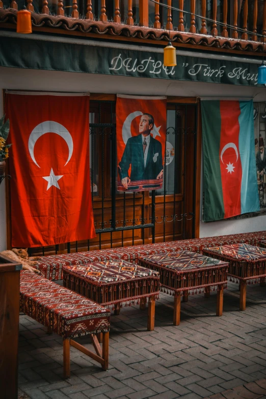 a row of benches with turkish flags hanging from the side of them