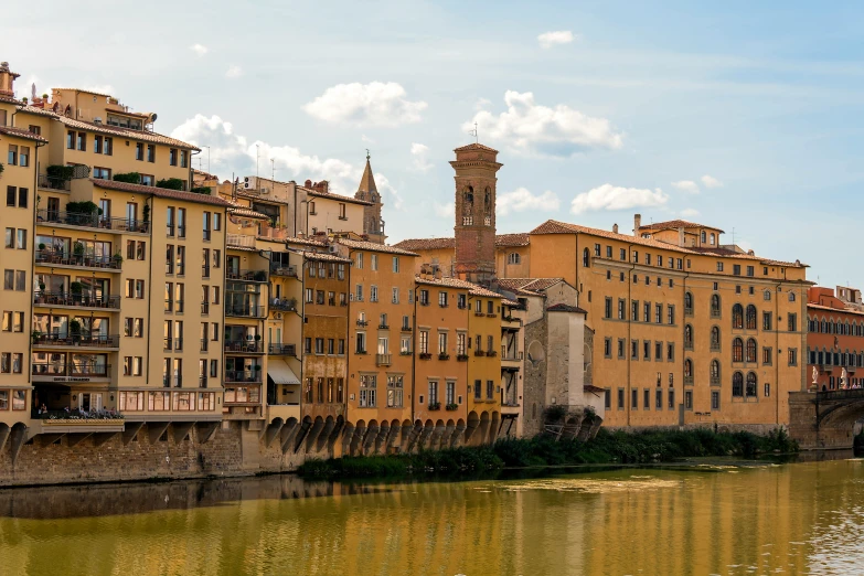 an old town with lots of houses sitting on the side of a river