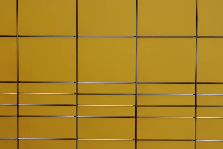 an animal stands in front of a grid fence