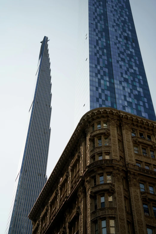 two very tall buildings are in the sky