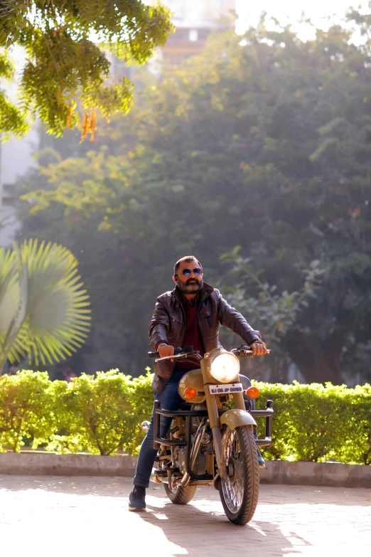 a man riding on the back of a motorcycle down a street