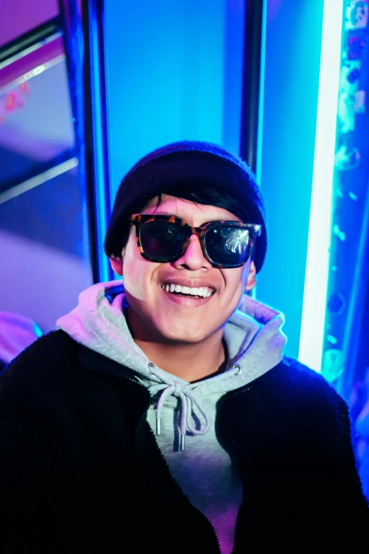 smiling man in shades wearing black hat and sunglasses