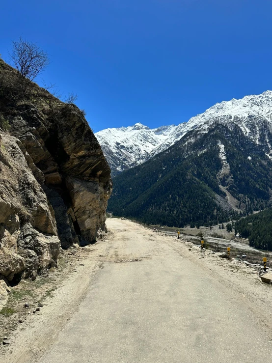 a dirt road with two steep mountain sides