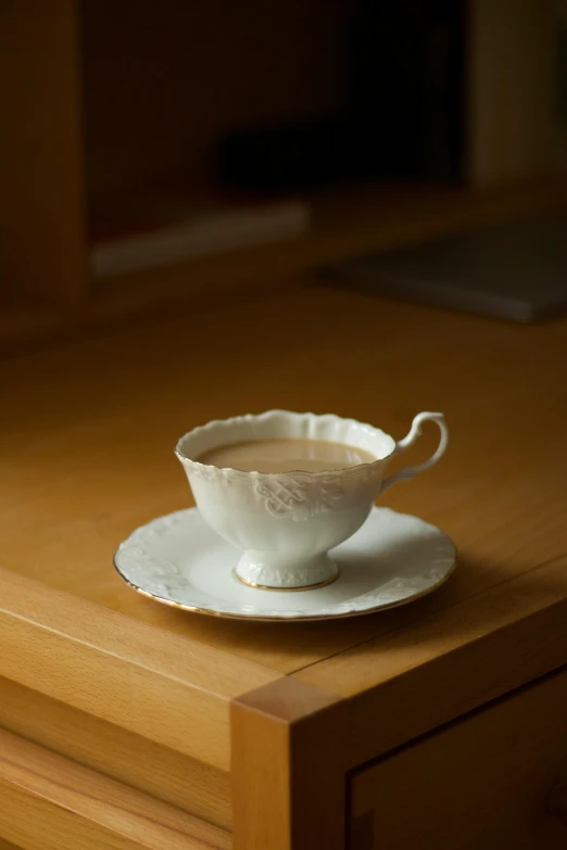 a small cup with a saucer and spoon on it