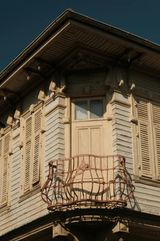 an old style balcony and shutters on a building