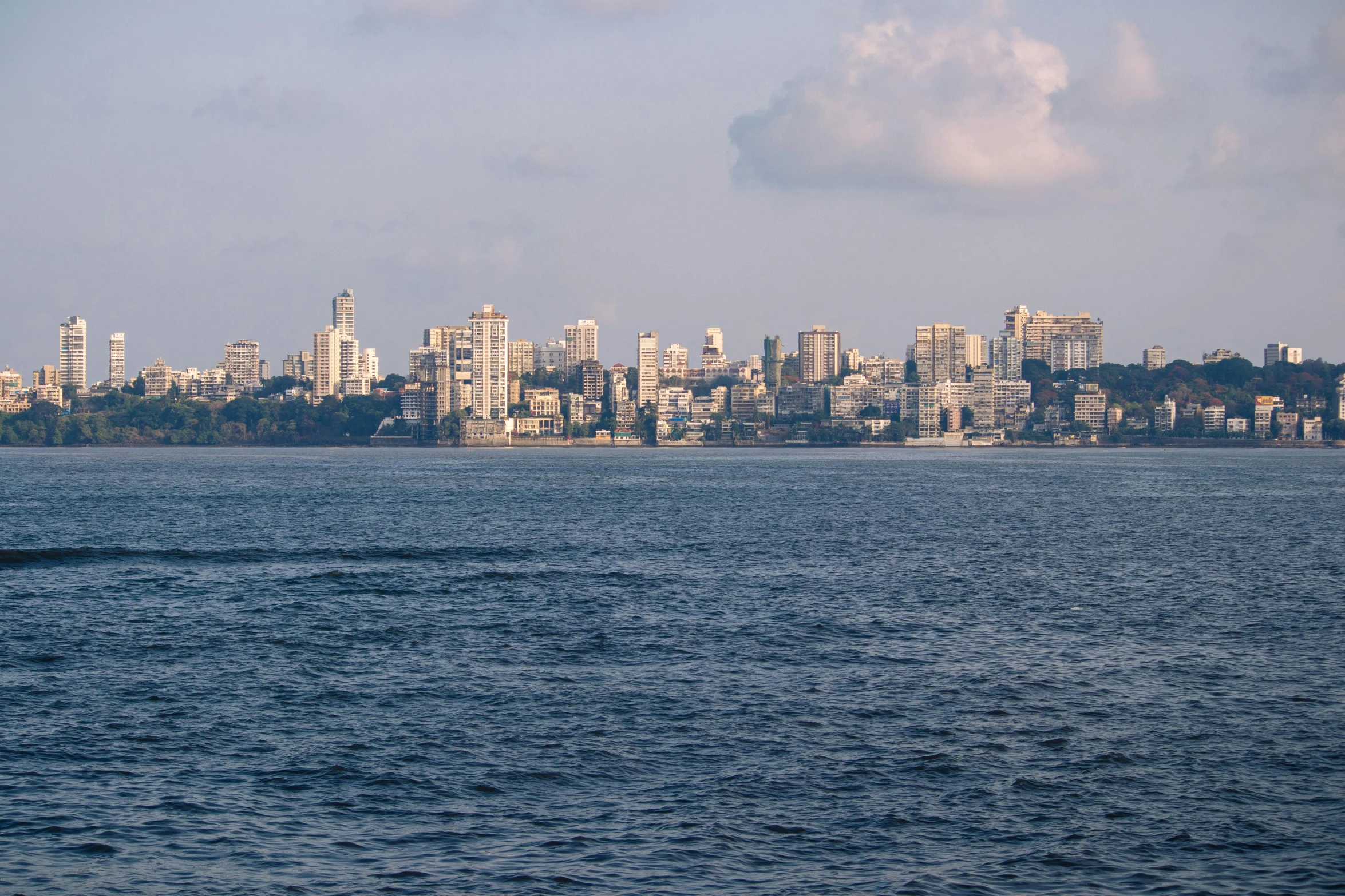 a city view taken from a boat looking towards a lake