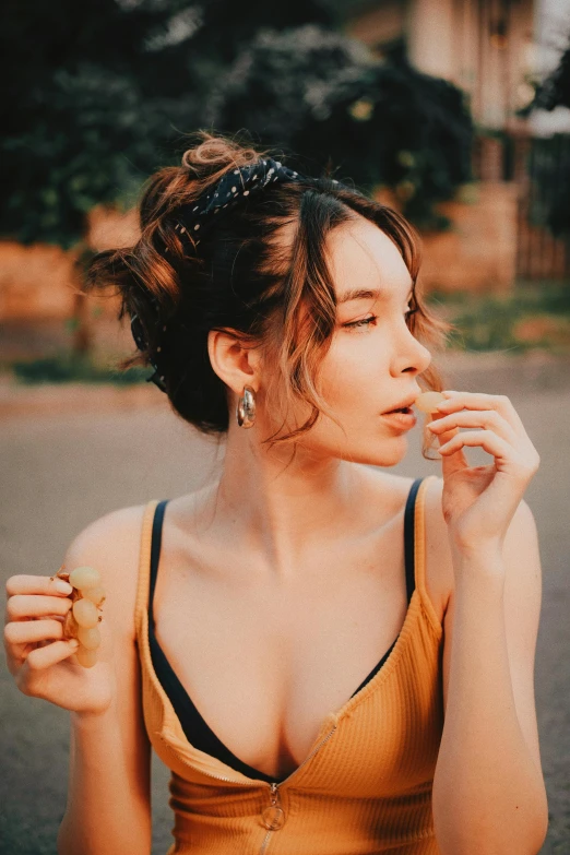 woman wearing yellow tank top posing for the camera