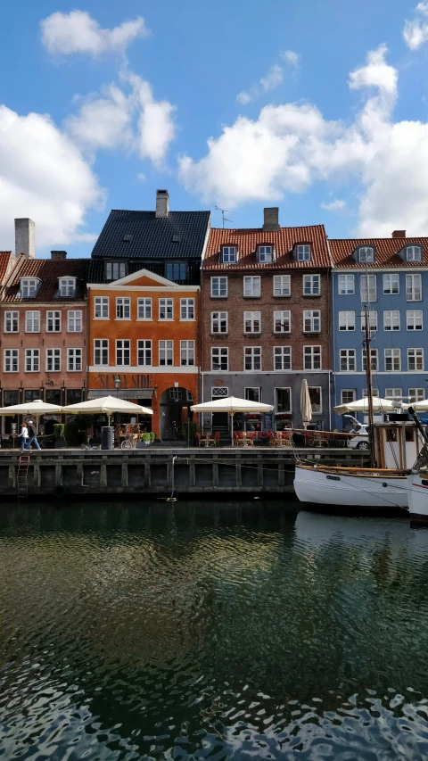 the view from a bridge of boats docked next to buildings