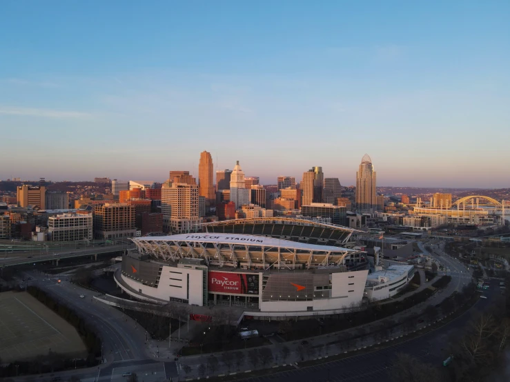 the city skyline with a stadium in the foreground