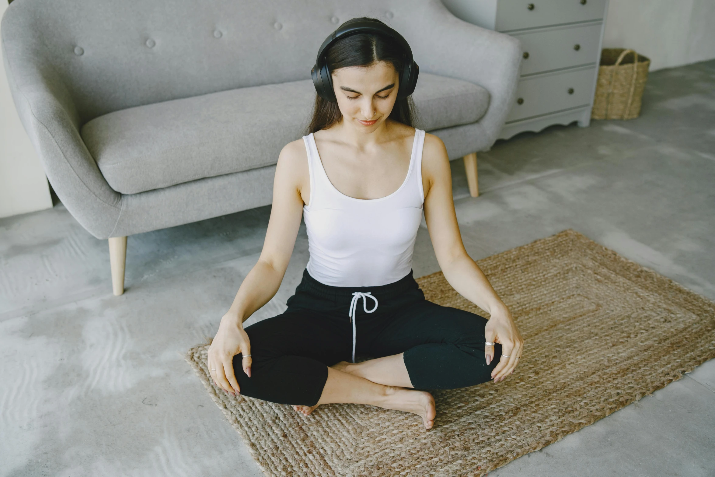 the woman in the white top is doing yoga