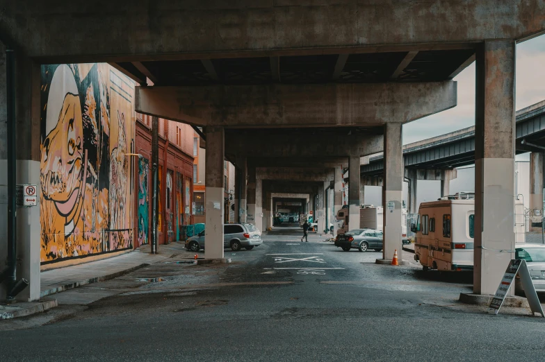 an overpass with graffiti and other vehicles on it